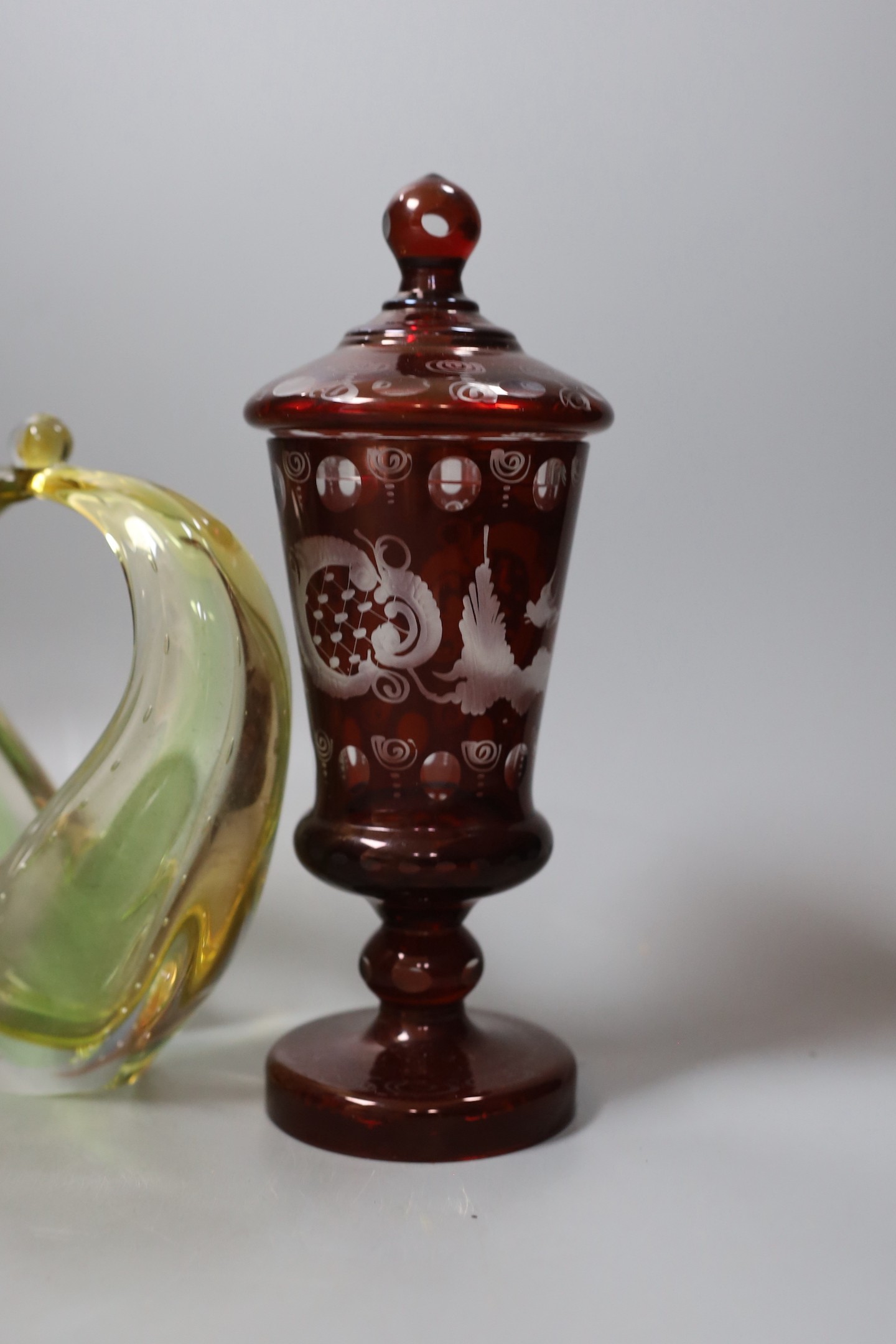 A Bohemian yellow and blue glass goblet, red overlaid vase and cover, another glass jar and cover and a Murano basket, tallest 24cm